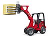Schaffer Hoflader 2630 con forca per balle e 1 bal