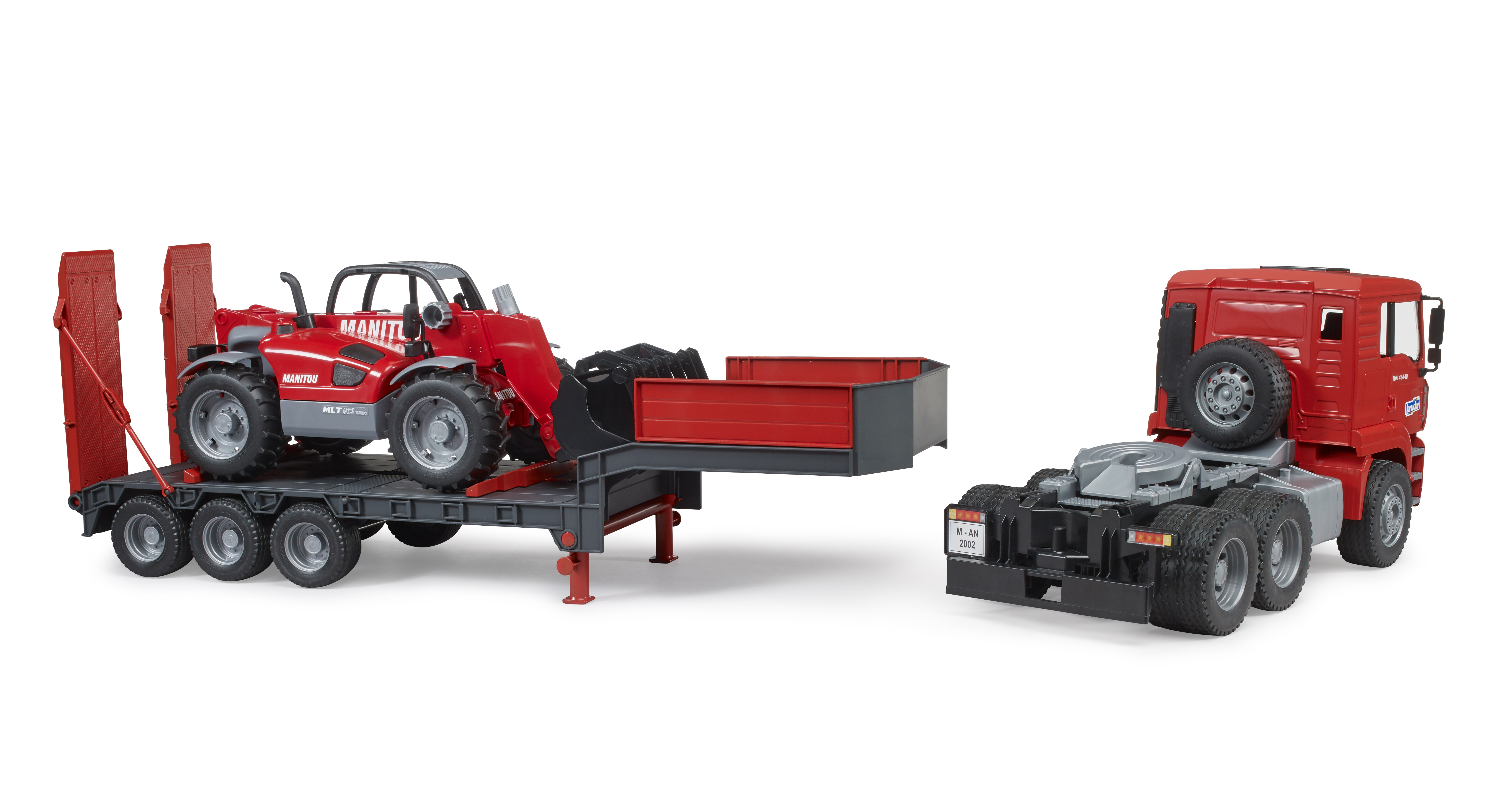 Camion MAN TGA con rimorchio a pianale ribassato e caricatore telescopico Manitou Camion MAN TGA con rimorchio a pianale ribassato e caricatore telescopico Manitou