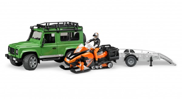 Land Rover Defender Station Wagon mit Anhänger, Snowmobil, Fahrer und Zubehör